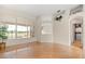 Living area with wood floors, a pool view, and an arched doorway at 1091 Hampstead Ln, Ormond Beach, FL 32174