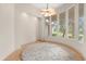 Bright living area with large windows offering natural light and hardwood flooring with a plush round rug at 1091 Hampstead Ln, Ormond Beach, FL 32174