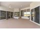 Large indoor patio with ceiling fan and lots of natural light and golf course view at 1091 Hampstead Ln, Ormond Beach, FL 32174