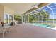 Covered patio with ceiling fans overlooking a pool and scenic lake view at 1091 Hampstead Ln, Ormond Beach, FL 32174