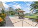 Screened in patio with pool and view of lake and blue skies at 1091 Hampstead Ln, Ormond Beach, FL 32174