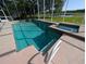 In-ground screened pool and spa overlooking lush landscaping, pond, and golf course at 1091 Hampstead Ln, Ormond Beach, FL 32174