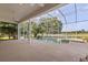 Relaxing screened-in pool area with lush landscaping and serene water views at 1091 Hampstead Ln, Ormond Beach, FL 32174
