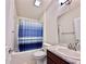 Bathroom featuring shower-tub combo with tile surround, vanity and framed mirror at 1171 Legatto Loop, Dundee, FL 33838