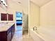 Bathroom featuring double sink vanity, soaking tub, and ceramic tile flooring at 1171 Legatto Loop, Dundee, FL 33838