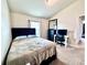 Bedroom with natural light, neutral colored carpet, and a large window at 1171 Legatto Loop, Dundee, FL 33838