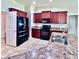 Beautiful kitchen with dark wood cabinets, modern appliances, and tiled flooring at 1171 Legatto Loop, Dundee, FL 33838