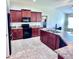 Well-equipped kitchen with sleek appliances, tiled floors, and ample counter space at 1171 Legatto Loop, Dundee, FL 33838