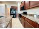 Functional kitchen with black appliances, tiled floors, and stone countertops at 1171 Legatto Loop, Dundee, FL 33838