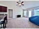 Bright living room featuring modern furnishings, neutral carpet, and a view to the backyard at 1171 Legatto Loop, Dundee, FL 33838