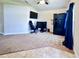 Open-concept living room with neutral carpeting, a ceiling fan, and ample space at 1171 Legatto Loop, Dundee, FL 33838