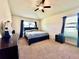 Comfortable main bedroom featuring neutral tones, carpet flooring, and a ceiling fan at 1171 Legatto Loop, Dundee, FL 33838