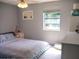 Bright bedroom with a comfortable bed, stylish bedding, and ample natural light from the window at 15 Estrella Rd, Debary, FL 32713