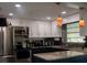 Modern kitchen with stainless steel appliances, granite countertops, and pendant lighting at 15 Estrella Rd, Debary, FL 32713