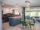 Eat-in kitchen with island and stainless steel appliances, next to outdoor patio seating at 15 Estrella Rd, Debary, FL 32713