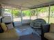 Cozy screened patio featuring comfortable seating and string lights for relaxed outdoor living at 15 Estrella Rd, Debary, FL 32713