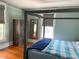 Inviting bedroom featuring neutral tones, modern finishes, natural light, and hardwood floors at 209 E 4Th St, Sanford, FL 32771