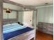 Cozy bedroom featuring a four poster bed, built in lighting, and hardwood floors at 209 E 4Th St, Sanford, FL 32771