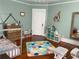 Bright bedroom with hardwood floors and ample storage with bookshelf and wall decor at 209 E 4Th St, Sanford, FL 32771