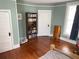 Light-filled bedroom with hardwood floors, built in bookshelf, and traditional trim at 209 E 4Th St, Sanford, FL 32771