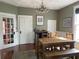 Charming dining room with a rustic table, elegant chandelier, and neutral walls that provide an inviting space at 209 E 4Th St, Sanford, FL 32771