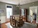 Traditional dining room featuring hardwood floors, a decorative chandelier, and a large hutch for display at 209 E 4Th St, Sanford, FL 32771