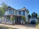 Charming two-story home with a welcoming porch and a well-maintained front yard with beautiful landscaping at 209 E 4Th St, Sanford, FL 32771