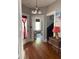 Inviting foyer featuring hardwood floors, elegant lighting fixture, and an open view into the living spaces at 209 E 4Th St, Sanford, FL 32771