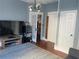 Inviting living room featuring a TV, mini-fridge, hardwood floors and french doors to another room at 209 E 4Th St, Sanford, FL 32771