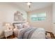 Comfortable bedroom with natural light, a cozy bed, and decorative wall shelves at 2637 Florence St, Orlando, FL 32818