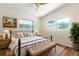 Bedroom with hardwood floors, two windows, and a comfortable king size bed at 2637 Florence St, Orlando, FL 32818