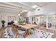 Open-concept dining room with wood floors, vaulted ceilings, beams, and a modern light fixture at 2637 Florence St, Orlando, FL 32818