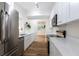 Updated kitchen features white cabinets, stainless steel appliances and hardwood flooring at 2637 Florence St, Orlando, FL 32818
