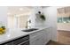 Modern kitchen featuring white cabinets, white countertops, stainless steel appliances, and gold fixtures at 2637 Florence St, Orlando, FL 32818