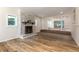 Bright living room with wood floors, decorative fireplace, and elevated adjoining room at 2637 Florence St, Orlando, FL 32818