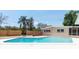 Backyard pool with fence, lush landscaping, privacy, and screened-in porch view at 2637 Florence St, Orlando, FL 32818