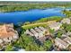 Gorgeous aerial view of townhomes and a large lake, featuring a gazebo, offering a serene community setting at 3480 Soho St # 107, Orlando, FL 32835