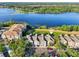 A scenic aerial view of the condo community on the lake with well maintained landscaping and common areas at 3480 Soho St # 107, Orlando, FL 32835
