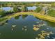 Beautiful aerial view featuring a lakeside gazebo, a walking path, and lush green vegetation at 3480 Soho St # 107, Orlando, FL 32835