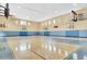 Spacious indoor basketball court featuring hardwood floors and multiple hoops, perfect for recreation at 3480 Soho St # 107, Orlando, FL 32835