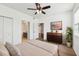 Bright bedroom with hardwood floors, ceiling fan, and a modern dresser at 3480 Soho St # 107, Orlando, FL 32835