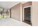 Exterior front door view on a covered entryway leading to stairway with painted stucco and modern hardware at 3480 Soho St # 107, Orlando, FL 32835