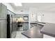 Well-lit kitchen featuring stainless steel appliances, dark counters, a skylight and a breakfast bar at 3480 Soho St # 107, Orlando, FL 32835