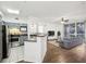 Bright open floor plan featuring a kitchen with breakfast bar, living room with a ceiling fan and sliding glass doors at 3480 Soho St # 107, Orlando, FL 32835