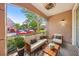 Cozy patio with comfortable seating and a view of the landscaped community at 3480 Soho St # 107, Orlando, FL 32835