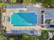 Top-down view of community pool with lounge chairs, gazebo and lush vegetation at 3480 Soho St # 107, Orlando, FL 32835
