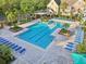 Aerial view of a community pool with lounge chairs and lush landscaping at 3480 Soho St # 107, Orlando, FL 32835
