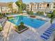 Aerial view of a large community pool with many lounge chairs and a gazebo at 3480 Soho St # 107, Orlando, FL 32835