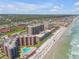 Gorgeous aerial shot of condos along the beach, offering stunning views and convenient access to the ocean at 4139 S Atlantic Ave # B707, New Smyrna Beach, FL 32169