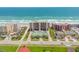 Aerial view showcasing oceanfront condos, well-maintained tennis courts, and beautifully landscaped surroundings, creating an inviting atmosphere at 4139 S Atlantic Ave # B707, New Smyrna Beach, FL 32169